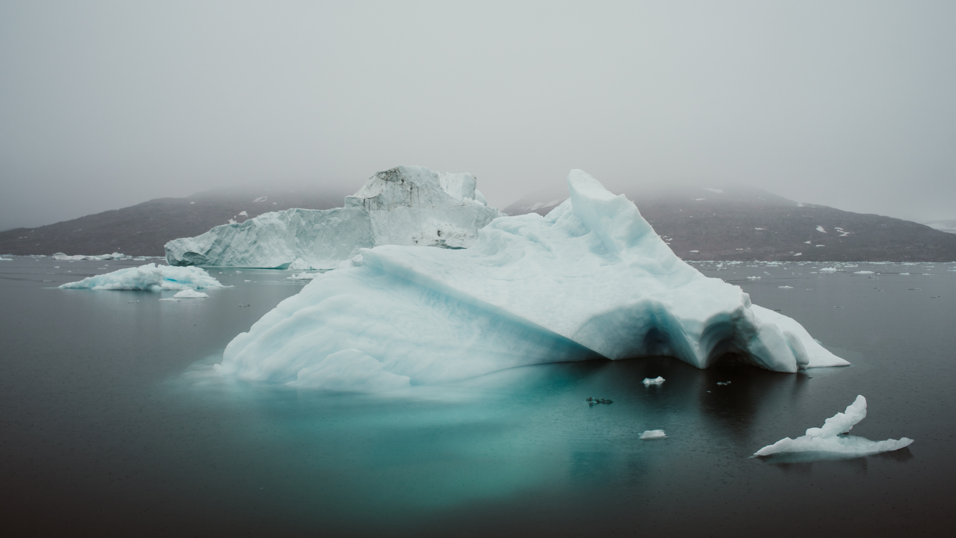 Iceberg in still turquoise water